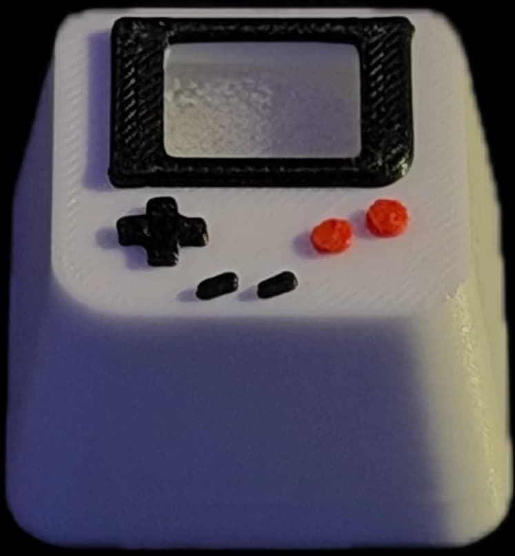 Console-shaped keycap with a miniature screen and red buttons